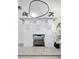 Elegant white brick fireplace with hearth, complemented by a stylish mirror and decorative plants at 112 E Plymouth St, Tampa, FL 33603