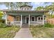 Charming two-story home featuring a cozy front porch and well-maintained landscaping at 112 E Plymouth St, Tampa, FL 33603