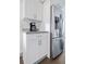 Well-lit kitchen featuring white cabinets, granite countertops, and stainless steel refrigerator at 112 E Plymouth St, Tampa, FL 33603