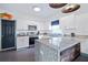 Modern kitchen featuring white cabinetry, stainless steel appliances, and unique granite countertops at 112 E Plymouth St, Tampa, FL 33603