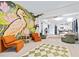 Open-concept living room featuring a large mural and seamless flow to the kitchen at 112 E Plymouth St, Tampa, FL 33603