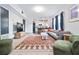 Bright, open living room featuring modern furnishings, colorful rug, and an open view to the kitchen at 112 E Plymouth St, Tampa, FL 33603