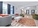 Bright living room with modern furniture, a vibrant rug, and large windows providing natural light at 112 E Plymouth St, Tampa, FL 33603
