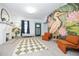 Comfortable living room with stylish decor, a decorative mural, and ample natural light at 112 E Plymouth St, Tampa, FL 33603