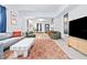Bright living room with modern furniture, a vibrant rug, and an open layout to additional rooms at 112 E Plymouth St, Tampa, FL 33603