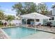 Inviting backyard pool area with a covered bar, lounge chairs, and lush landscaping for outdoor relaxation at 112 E Plymouth St, Tampa, FL 33603