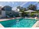 Relaxing backyard pool surrounded by lush landscaping, and lounge chairs at 112 E Plymouth St, Tampa, FL 33603