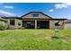 Expansive backyard featuring a screened-in porch perfect for outdoor entertaining and relaxation at 11911 Sunburst Marble Rd, Riverview, FL 33579