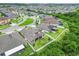 An aerial shot of the back of the home with a well-kept lawn and white vinyl fence bordering greenery at 11911 Sunburst Marble Rd, Riverview, FL 33579