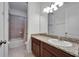 Neutral toned bathroom featuring granite counters, brown cabinetry, and a shower/tub combo at 11911 Sunburst Marble Rd, Riverview, FL 33579