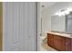 Half bath is shown, with a dark wood vanity, granite countertop, and double-door closet at 11911 Sunburst Marble Rd, Riverview, FL 33579