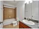 This bathroom features tile, a shower-tub combo and a vanity with granite counters at 11911 Sunburst Marble Rd, Riverview, FL 33579