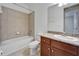 Bathroom features a shower-tub combo, a granite countertop, and wood cabinets at 11911 Sunburst Marble Rd, Riverview, FL 33579
