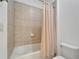 The bathroom includes a tiled shower-tub combo with a shower curtain and modern toilet at 11911 Sunburst Marble Rd, Riverview, FL 33579