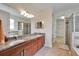 Bathroom featuring double vanities, a large mirror, and walk-in shower at 11911 Sunburst Marble Rd, Riverview, FL 33579