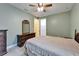 A green bedroom with a ceiling fan, large bed, dresser, and walk-in closet at 11911 Sunburst Marble Rd, Riverview, FL 33579
