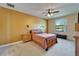 Relaxing bedroom offering natural light, neutral tones, ceiling fan, and soft carpeted floors at 11911 Sunburst Marble Rd, Riverview, FL 33579