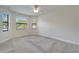 Bedroom featuring carpet, a ceiling fan, and several windows allowing plenty of natural light at 11911 Sunburst Marble Rd, Riverview, FL 33579