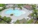 Aerial view of the community pool with ample seating and shaded areas at 11911 Sunburst Marble Rd, Riverview, FL 33579