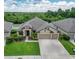 Stunning single-story home featuring a 3-car garage, manicured lawn and mature landscaping at 11911 Sunburst Marble Rd, Riverview, FL 33579