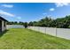 Fenced backyard featuring lush green lawn and vibrant blue sky, perfect for outdoor enjoyment at 11911 Sunburst Marble Rd, Riverview, FL 33579