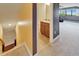 Hallway with carpeted floors offering views of a modern bathroom and a cozy living room area at 11911 Sunburst Marble Rd, Riverview, FL 33579