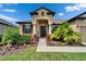 Beautiful home exterior showcases a well-maintained lawn with tropical plants and a welcoming entrance at 11911 Sunburst Marble Rd, Riverview, FL 33579