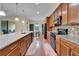 Island kitchen features modern appliances, granite countertops, wood cabinets and eat-in kitchen at 11911 Sunburst Marble Rd, Riverview, FL 33579