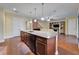 Spacious kitchen island featuring granite countertops and stainless steel appliances overlooking the living room at 11911 Sunburst Marble Rd, Riverview, FL 33579