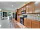 Island kitchen features modern appliances, granite countertops, wood cabinets and eat-in kitchen at 11911 Sunburst Marble Rd, Riverview, FL 33579