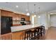 Island kitchen features modern appliances, granite countertops, and barstool seating at 11911 Sunburst Marble Rd, Riverview, FL 33579