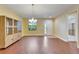 Bright living room with wood floors, decorative cabinet, and view of the front door and other room at 11911 Sunburst Marble Rd, Riverview, FL 33579