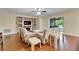 Living room featuring a fireplace, wood floors, comfortable seating, and open patio access at 11911 Sunburst Marble Rd, Riverview, FL 33579