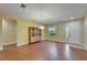 Bright living room with wood floors, decorative cabinet, and view of the front door at 11911 Sunburst Marble Rd, Riverview, FL 33579