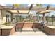 Outdoor kitchen with brickwork and modern stainless steel grills at 11911 Sunburst Marble Rd, Riverview, FL 33579