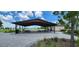 Covered picnic area with tables, benches, and a serene view of the surrounding green space at 11911 Sunburst Marble Rd, Riverview, FL 33579