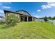 Spacious backyard with screened-in patio, lush green lawn, bordered by white fencing at 11911 Sunburst Marble Rd, Riverview, FL 33579