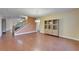 Open-concept living room with hardwood floors, chandelier and staircase at 11911 Sunburst Marble Rd, Riverview, FL 33579