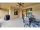 Covered and screened patio area featuring a ceiling fan and an outdoor dining set at 11911 Sunburst Marble Rd, Riverview, FL 33579