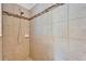 Shower featuring neutral toned tile surround and a shower head at 11911 Sunburst Marble Rd, Riverview, FL 33579
