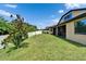 This backyard features a well maintained lawn, white vinyl fence and mature landscaping at 11911 Sunburst Marble Rd, Riverview, FL 33579
