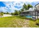Spacious backyard view of the screened-in lanai, pool, and white privacy fence at 12106 Clearbrook Ct, Riverview, FL 33569