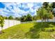 The property has a large, well-maintained backyard and a beautiful white privacy fence at 12106 Clearbrook Ct, Riverview, FL 33569