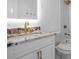 Modern bathroom featuring white vanity with granite countertop, LED mirror, and stylish fixtures at 12106 Clearbrook Ct, Riverview, FL 33569