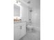 Chic bathroom boasting white tiles, granite vanity top, and modern gold shower fixtures at 12106 Clearbrook Ct, Riverview, FL 33569