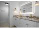 Bright bathroom with double sink vanity featuring a granite countertop and LED mirror at 12106 Clearbrook Ct, Riverview, FL 33569