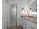 Stylish bathroom features a white vanity with granite countertop and backlit mirror at 12106 Clearbrook Ct, Riverview, FL 33569