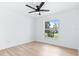 A bright bedroom features laminate floors, ceiling fan, and a window view at 12106 Clearbrook Ct, Riverview, FL 33569