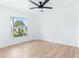 Bright bedroom with laminate floors, ceiling fan, and a large window view at 12106 Clearbrook Ct, Riverview, FL 33569