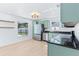 Bright kitchen featuring stainless appliances, green cabinets, granite counters, and a view to the yard at 12106 Clearbrook Ct, Riverview, FL 33569